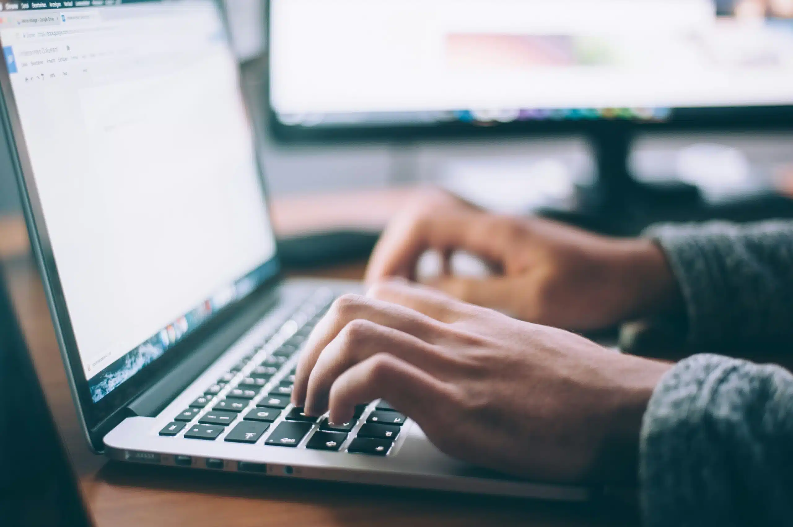 a person typing into a computer