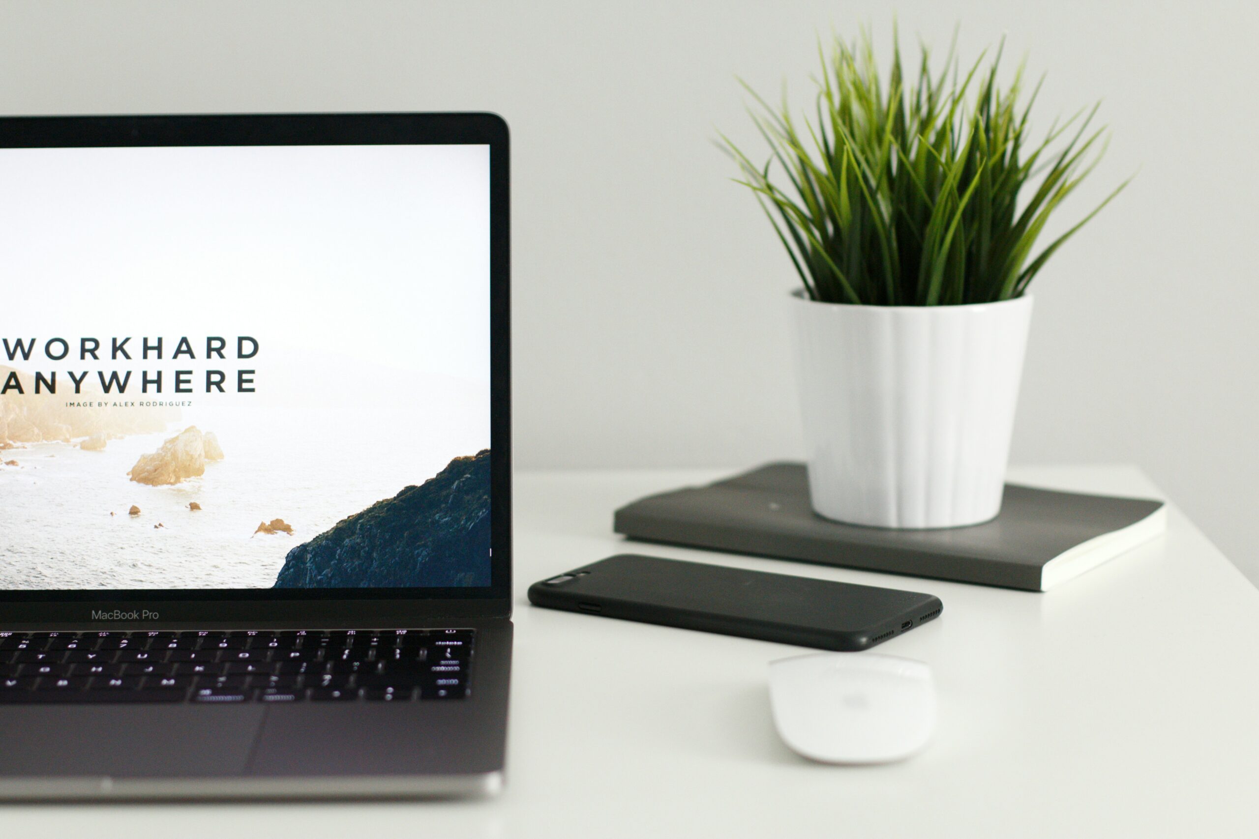 a clean white workspace with laptop and mouse - AI Marketing Tools a clean white workspace with laptop and mouse
