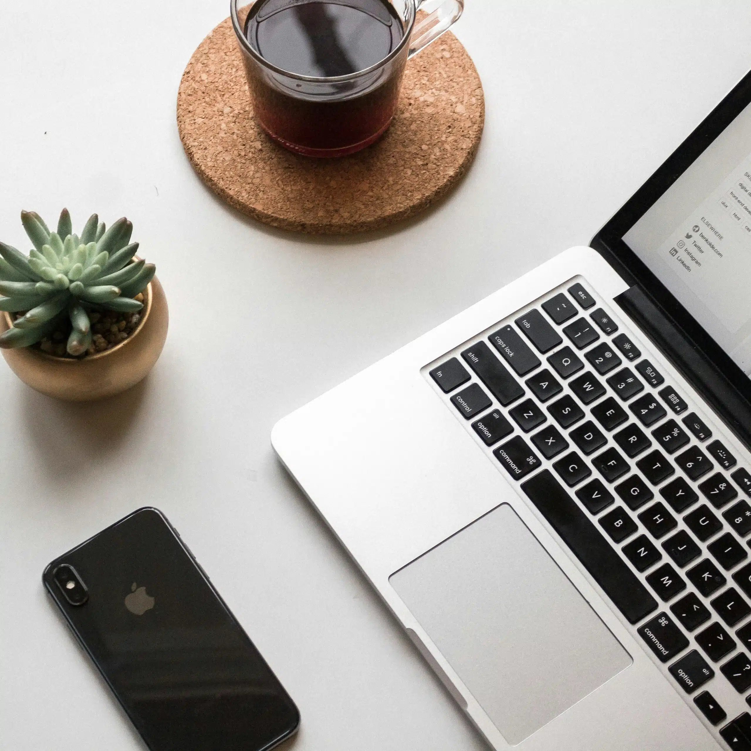Close-up of a laptop and coffee