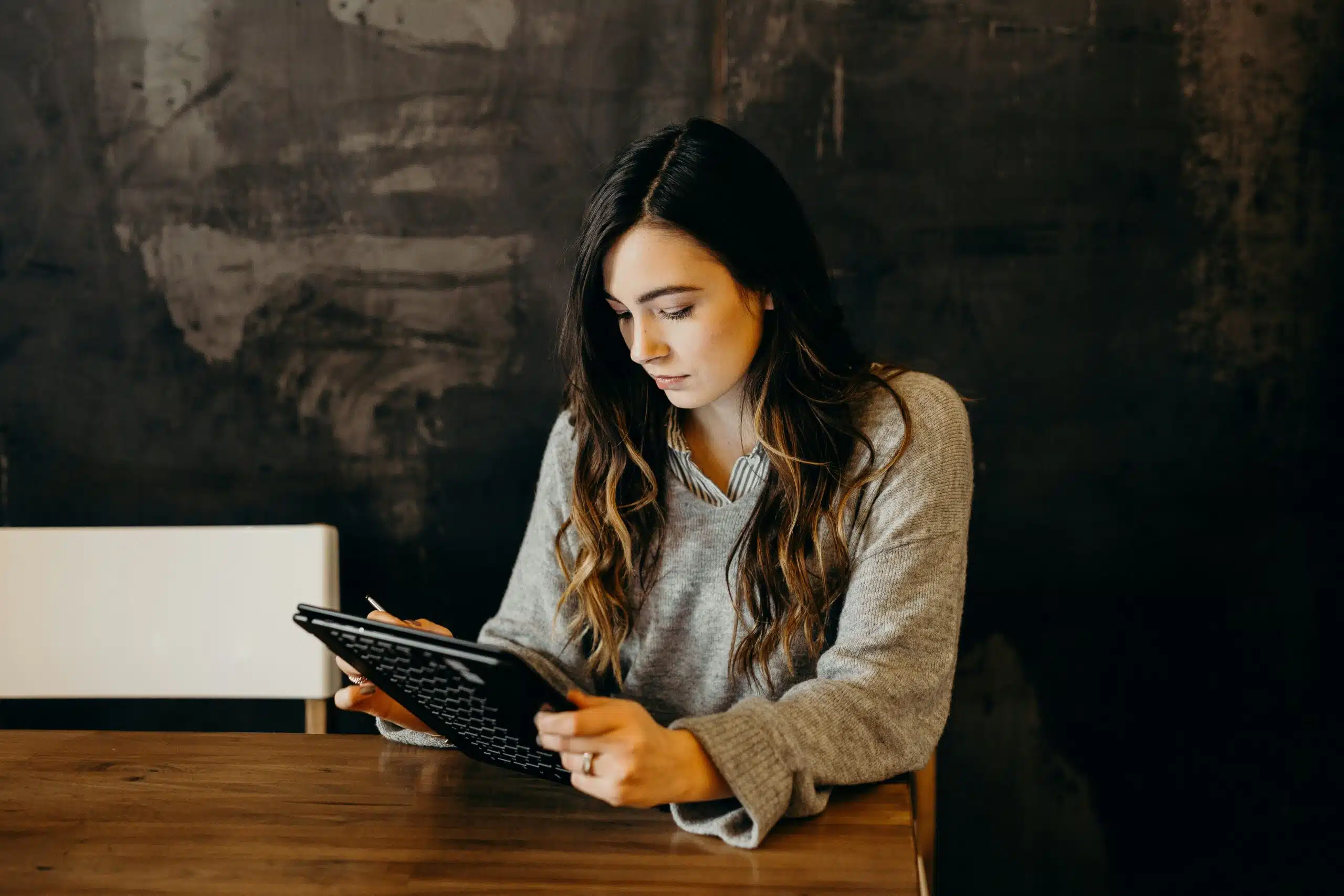 Woman reviewing digital performance reports on tablet