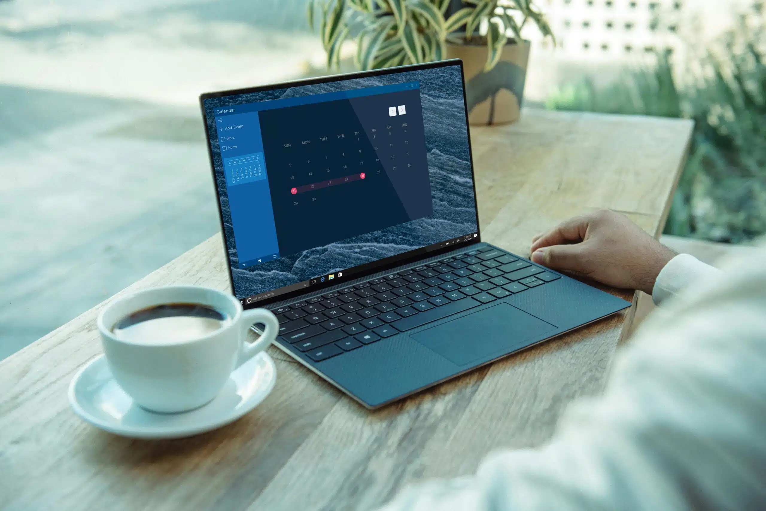 a person working on a laptop at an outdoor cafe