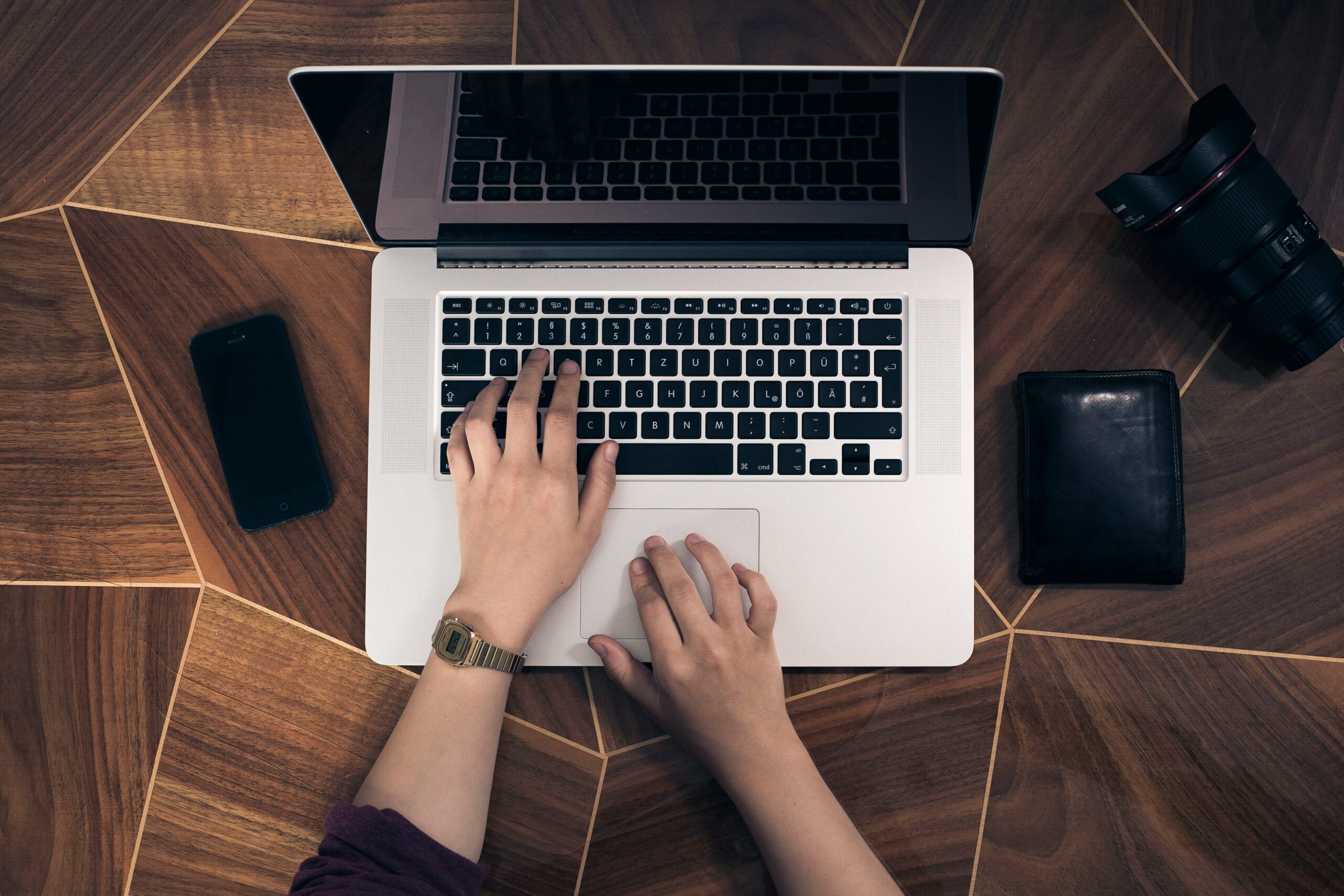 a pair of hands tying into the laptop