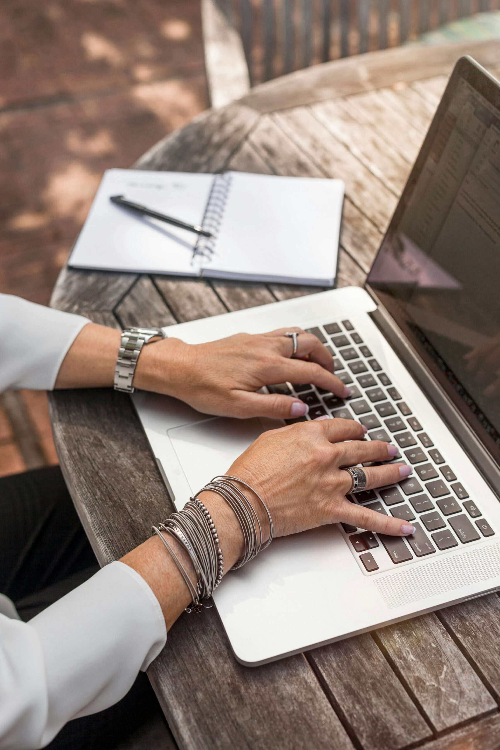 a woman typing into the laptop selecting the right Customer Engagement Tools