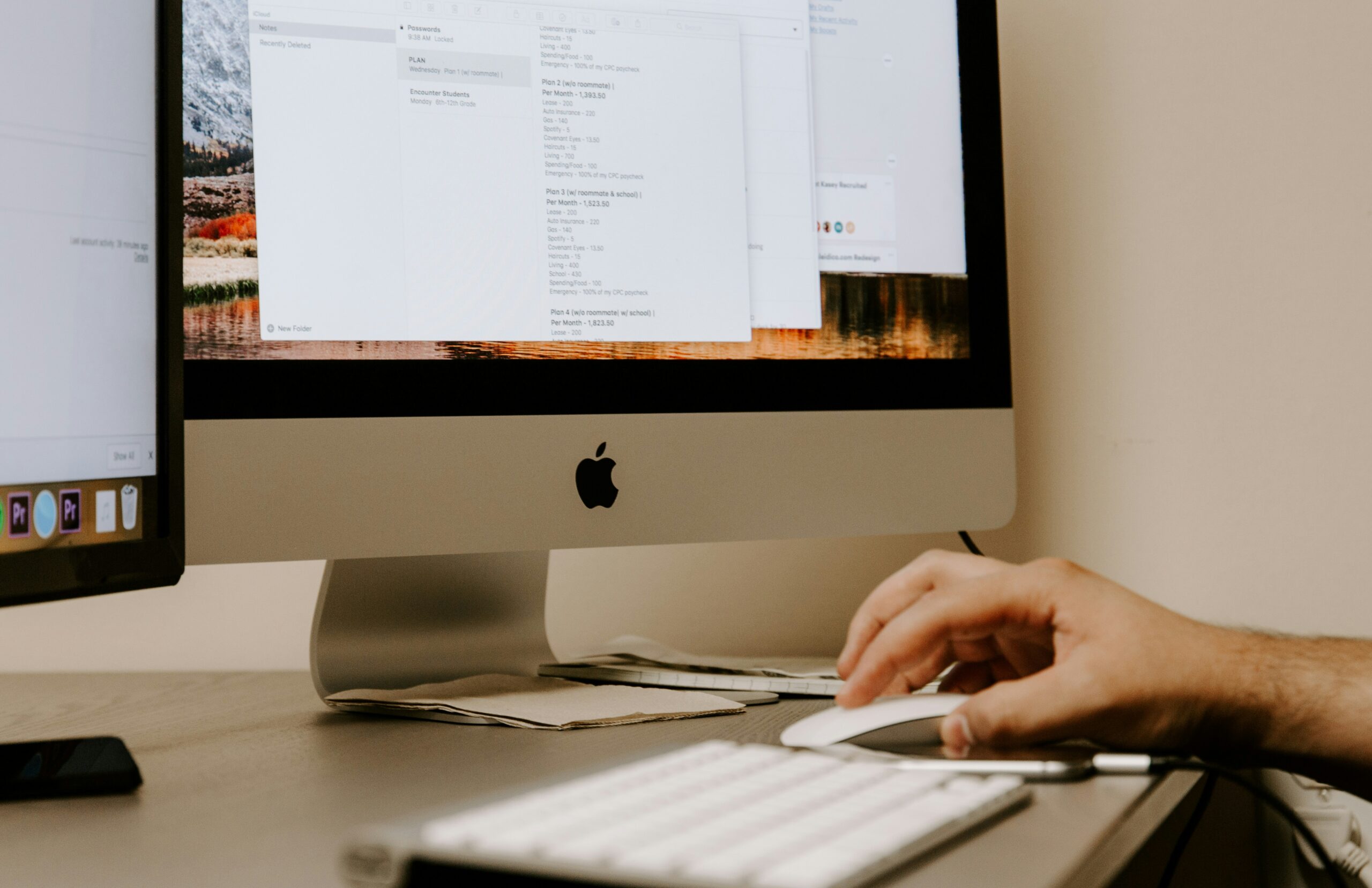  Person using an iMac with a document open on the screen