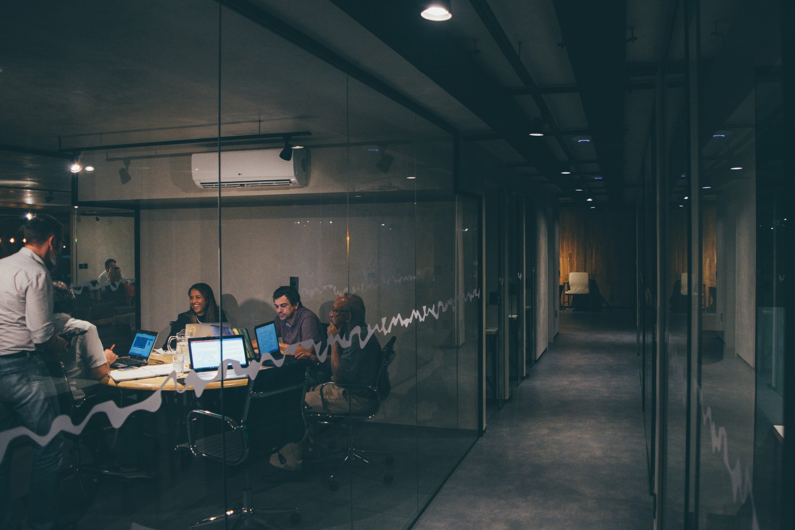 A modern conference room with a team collaborating on AI-driven content creation tools.