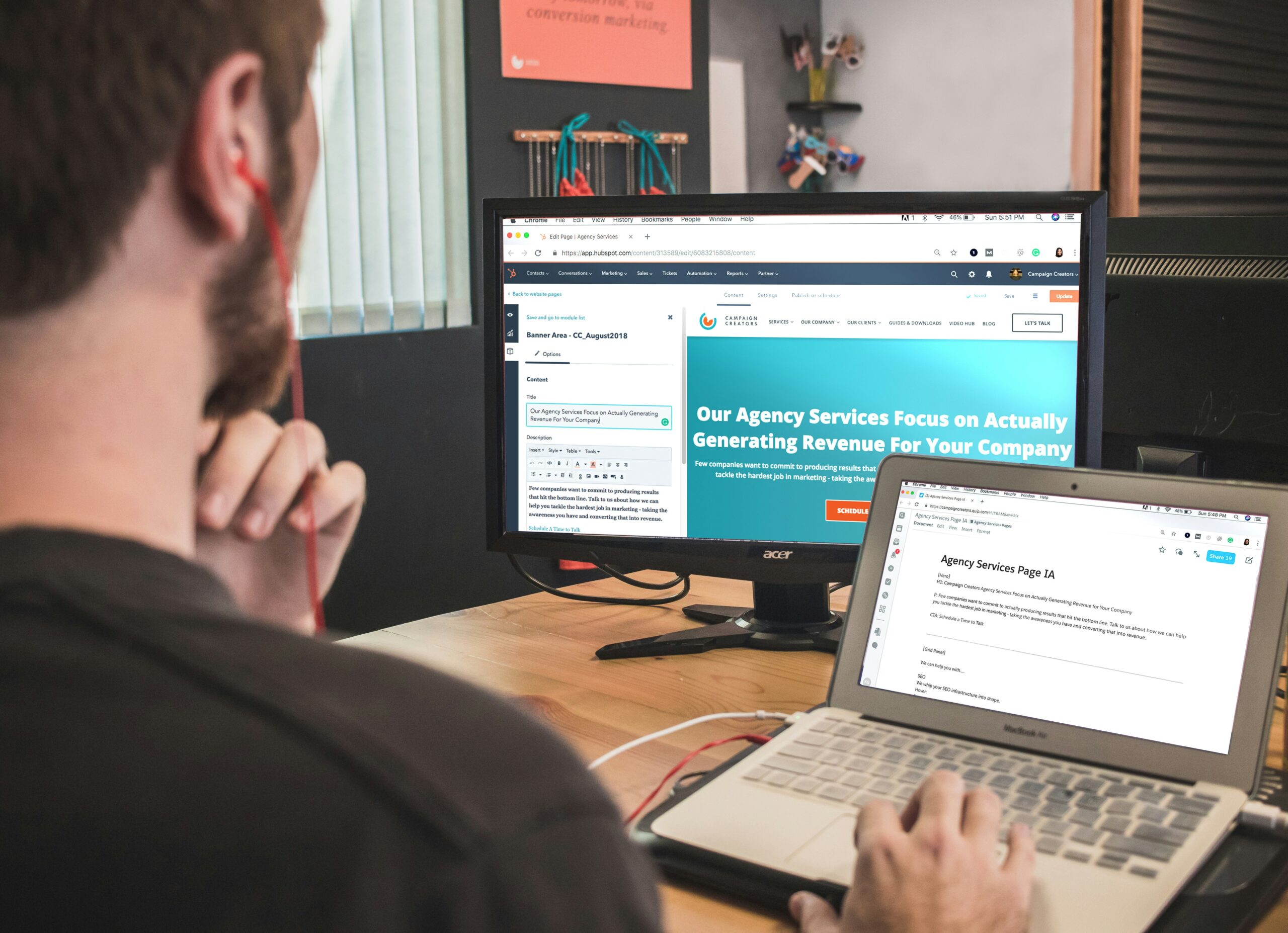 a person working with two computers at the same time