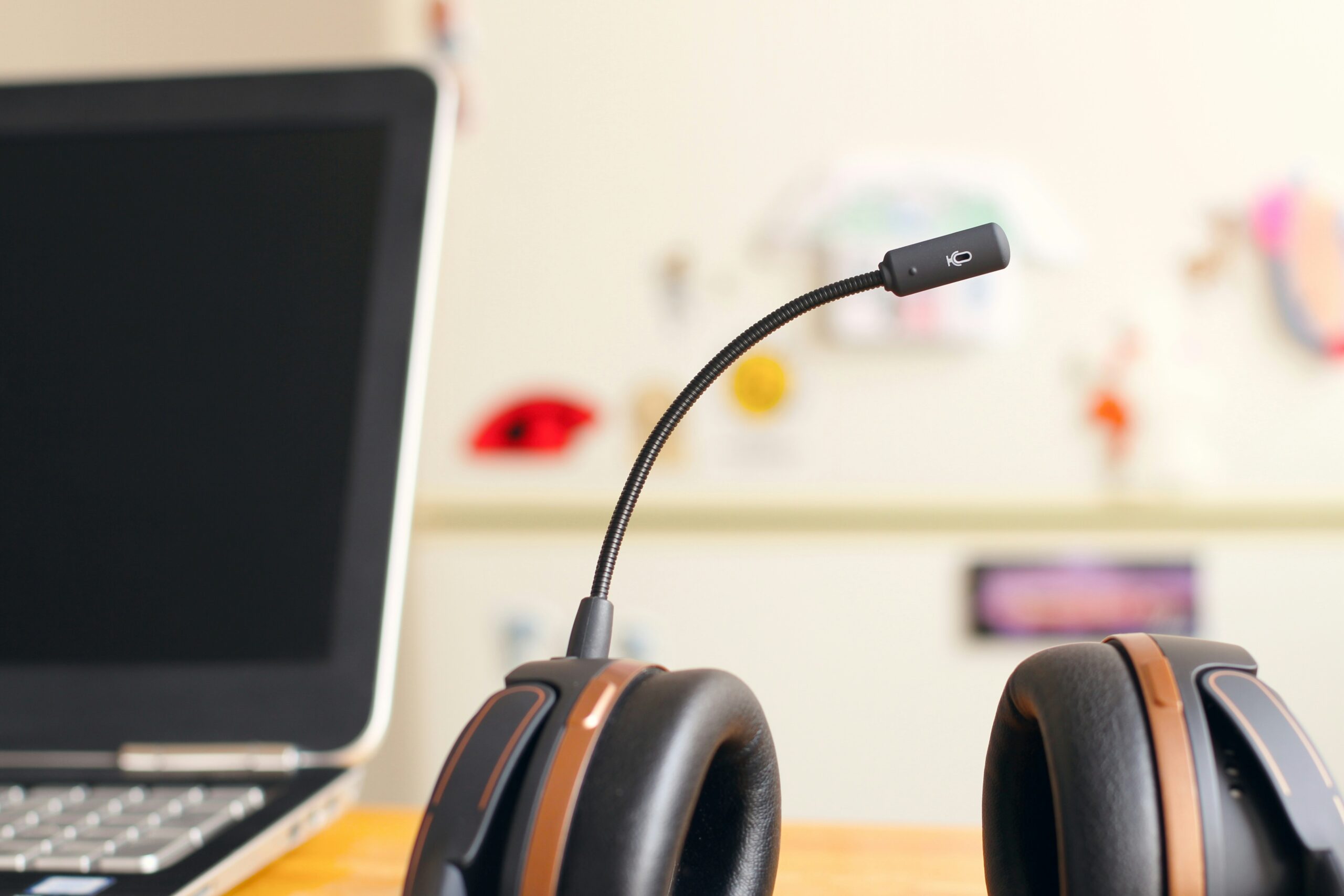 a desk with headphones and laptop