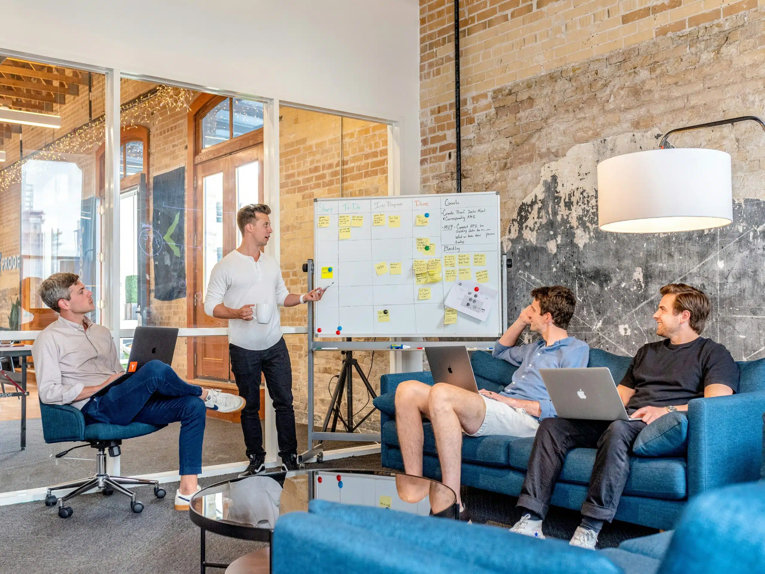 A team discussing SEO strategies with a whiteboard in a modern office.