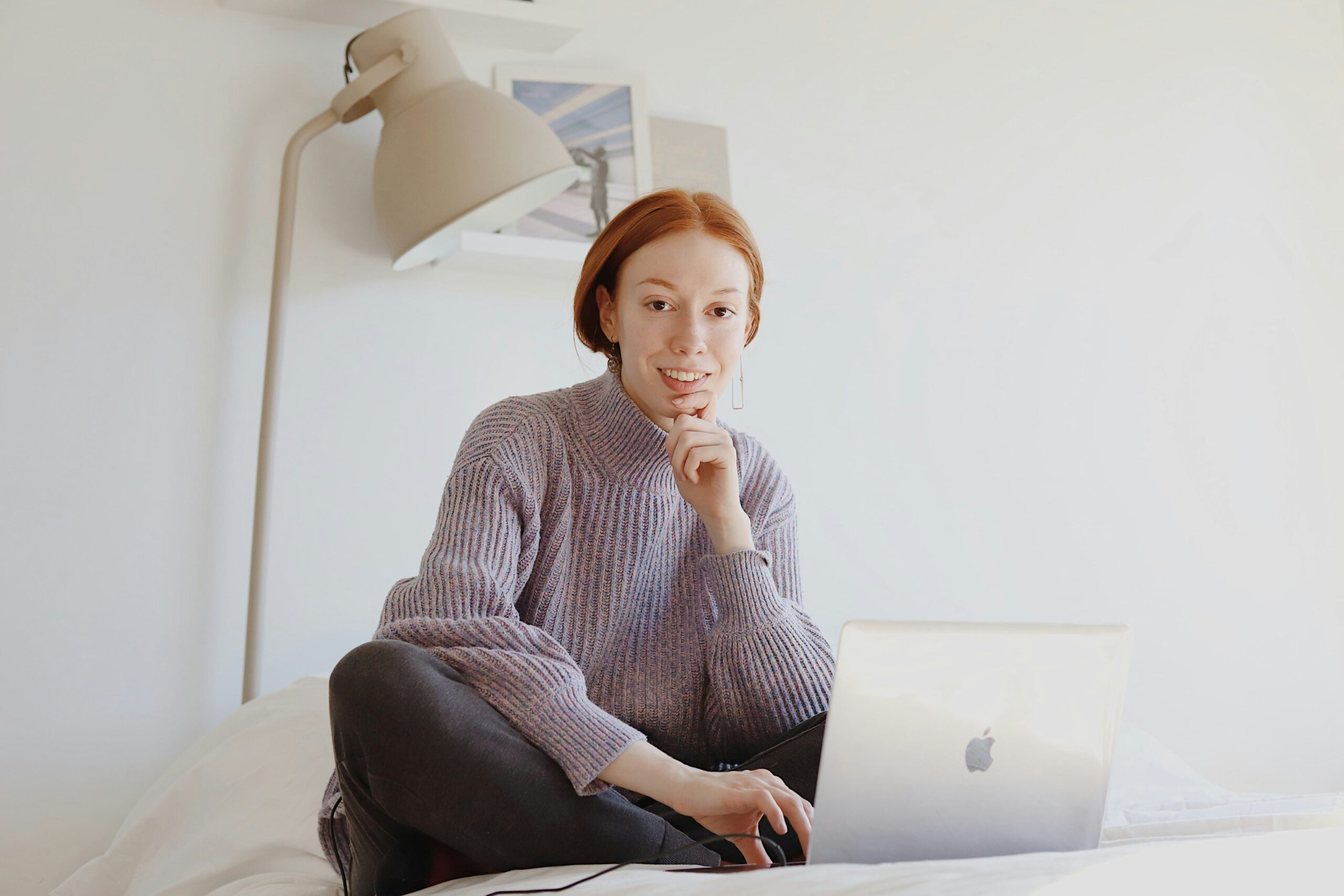 a person using a laptop and smiling