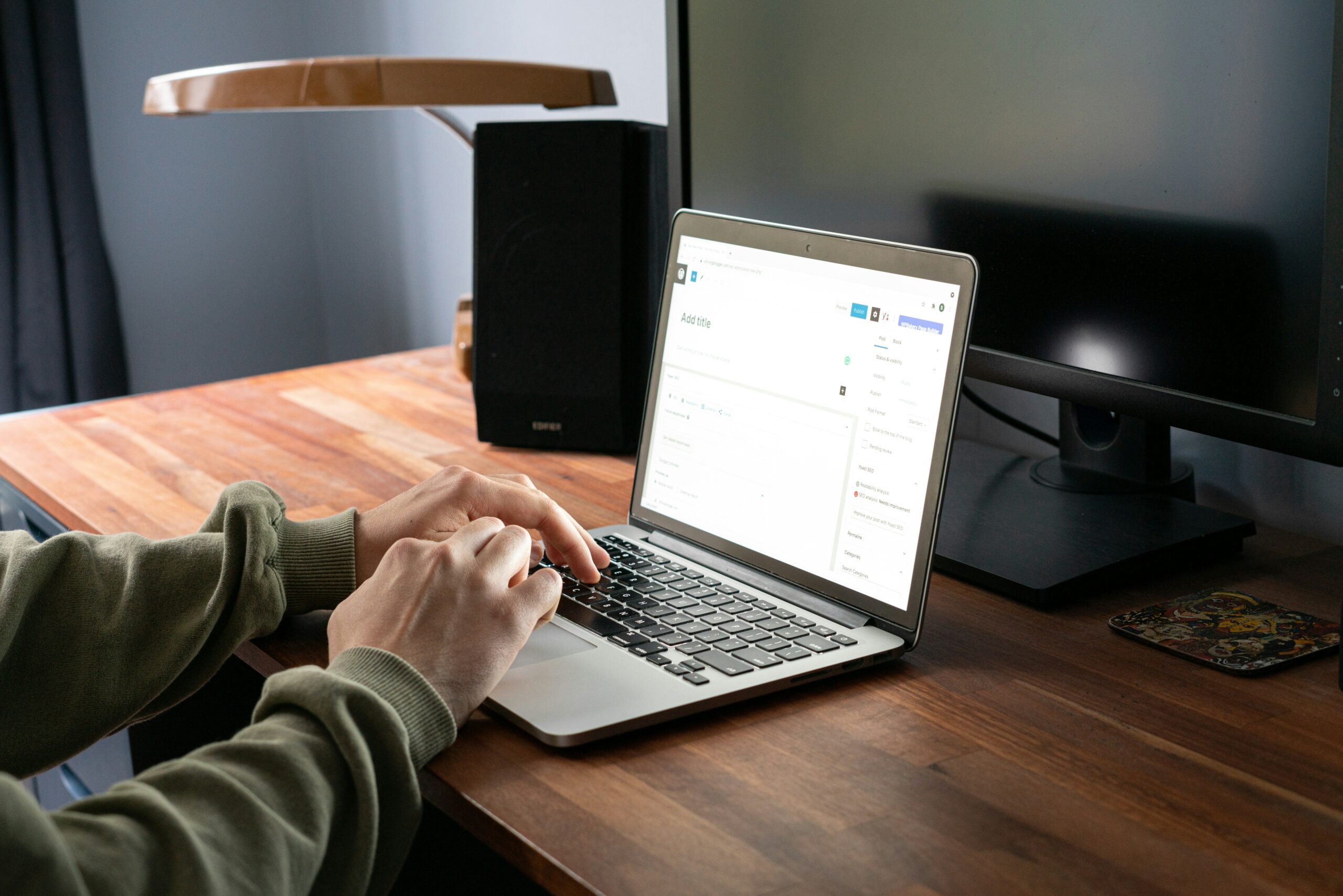 Hands typing on a laptop in a workspace, depicting a comprehensive evaluation of AI writing tools.