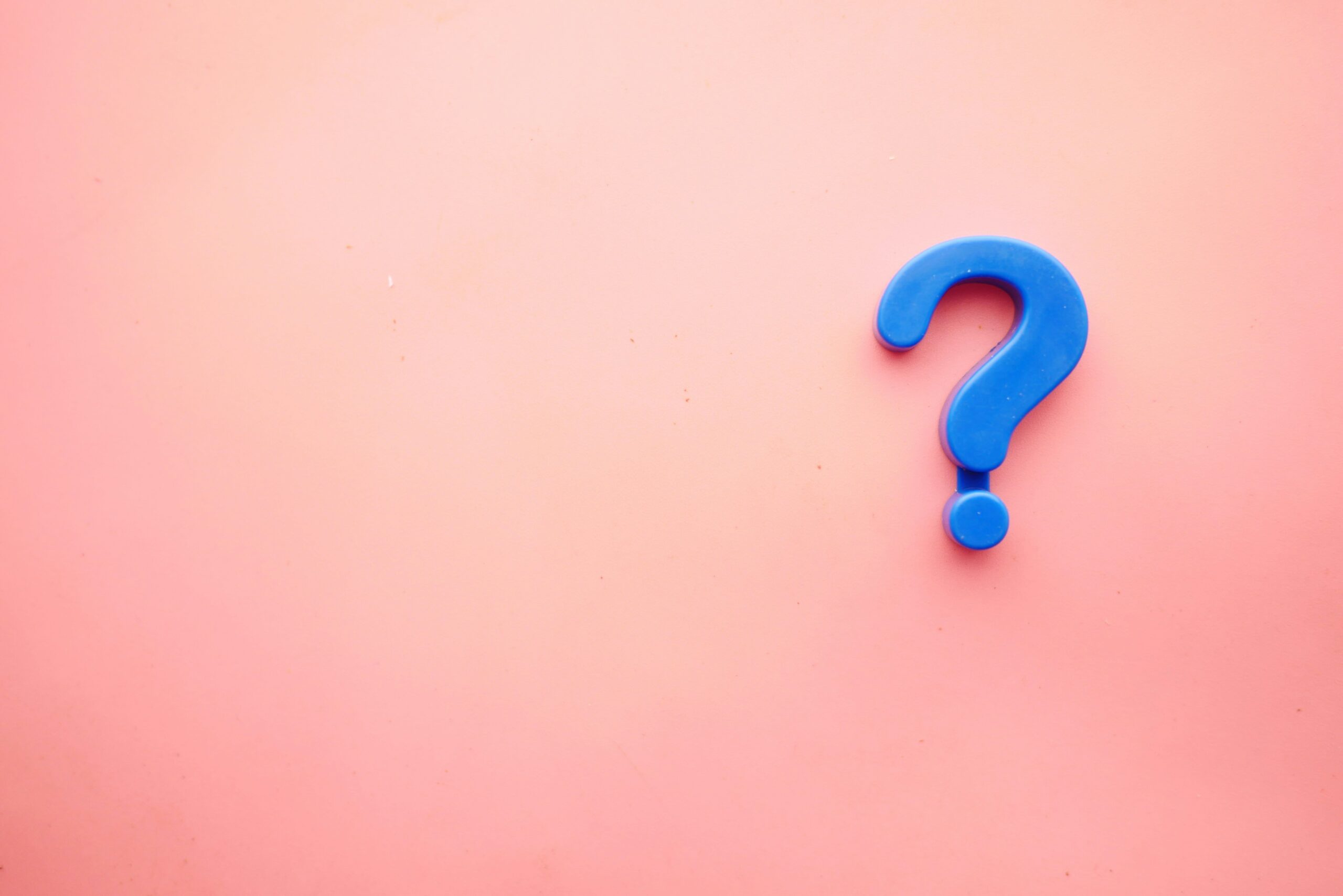 a question mark in a pink background