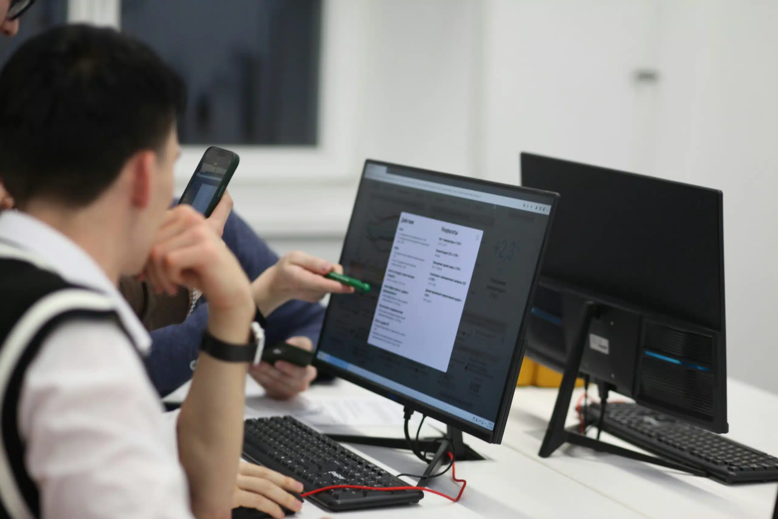 group of professionals analyzing PPC bid strategies on a large screen