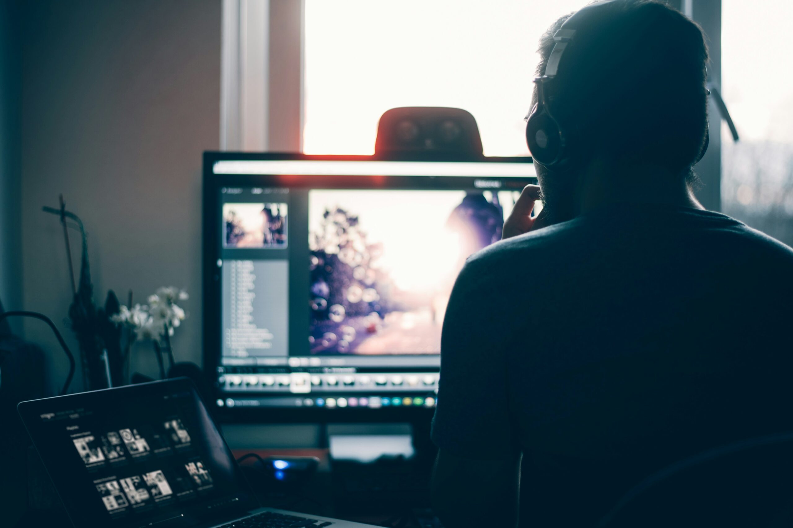 A data analyst working on a dual-monitor setup, reviewing AI-driven insights versus traditional data analysis methods.