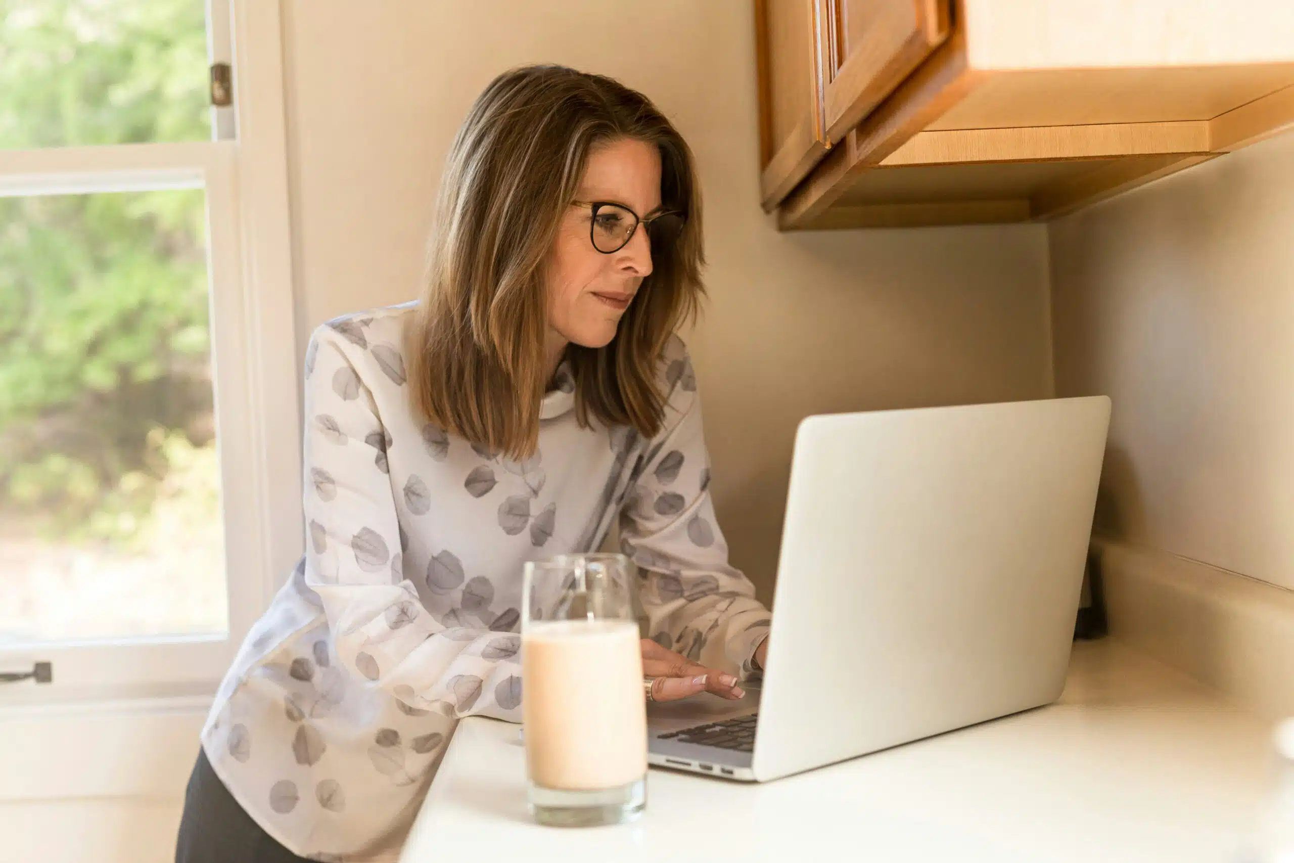 a woman working on something on laptop