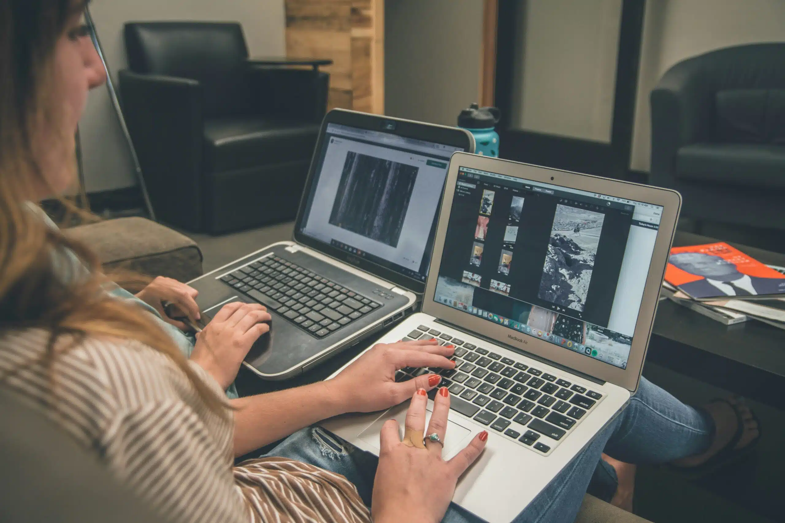 Two professionals working on AI-driven ad management tools on laptops