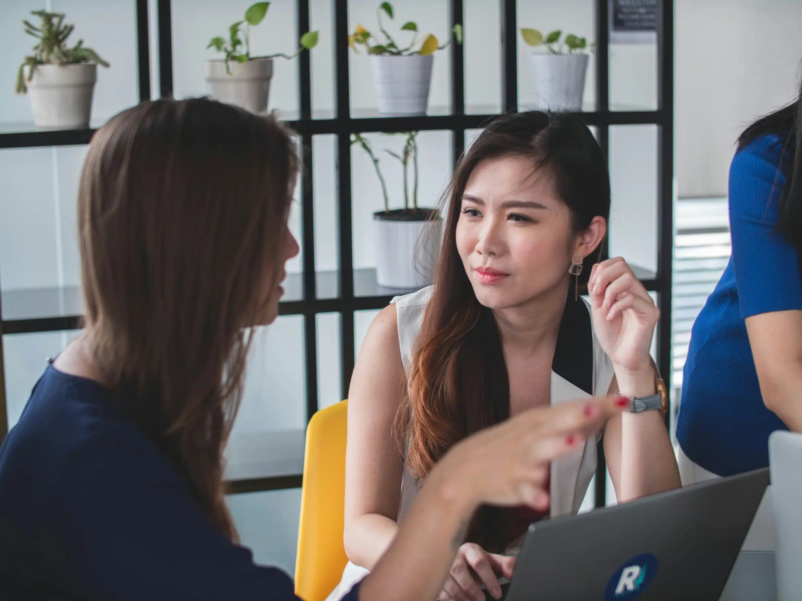 two women working together on a chatbot project