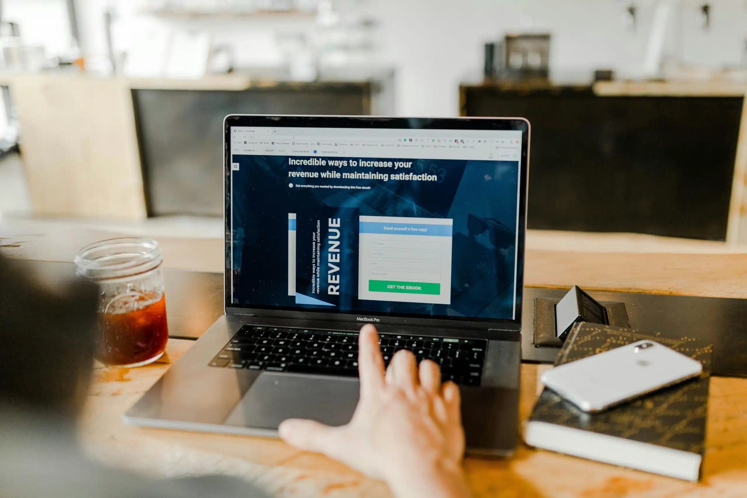 A person interacting with a laptop screen that displays an ad revenue optimization tool