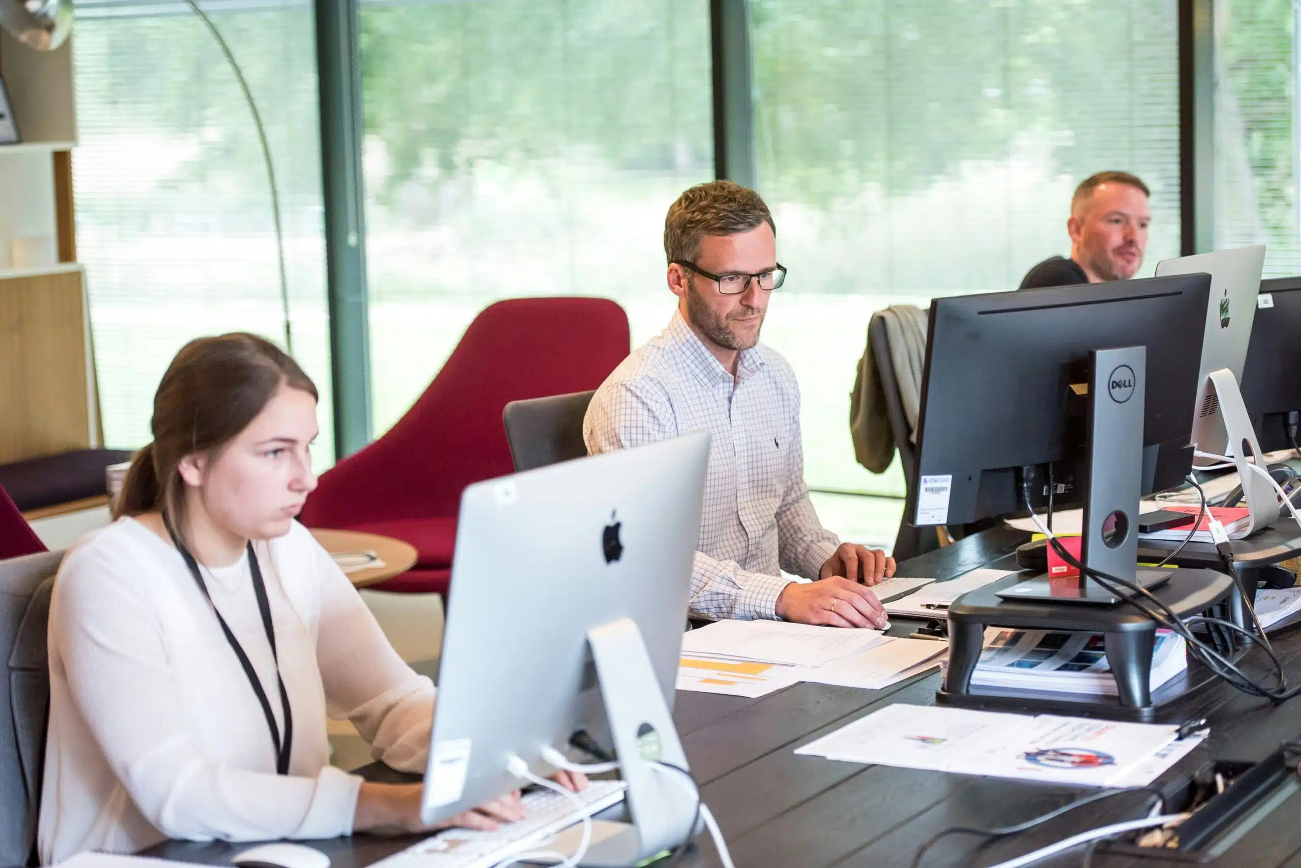 an office with professionals working on their desktops