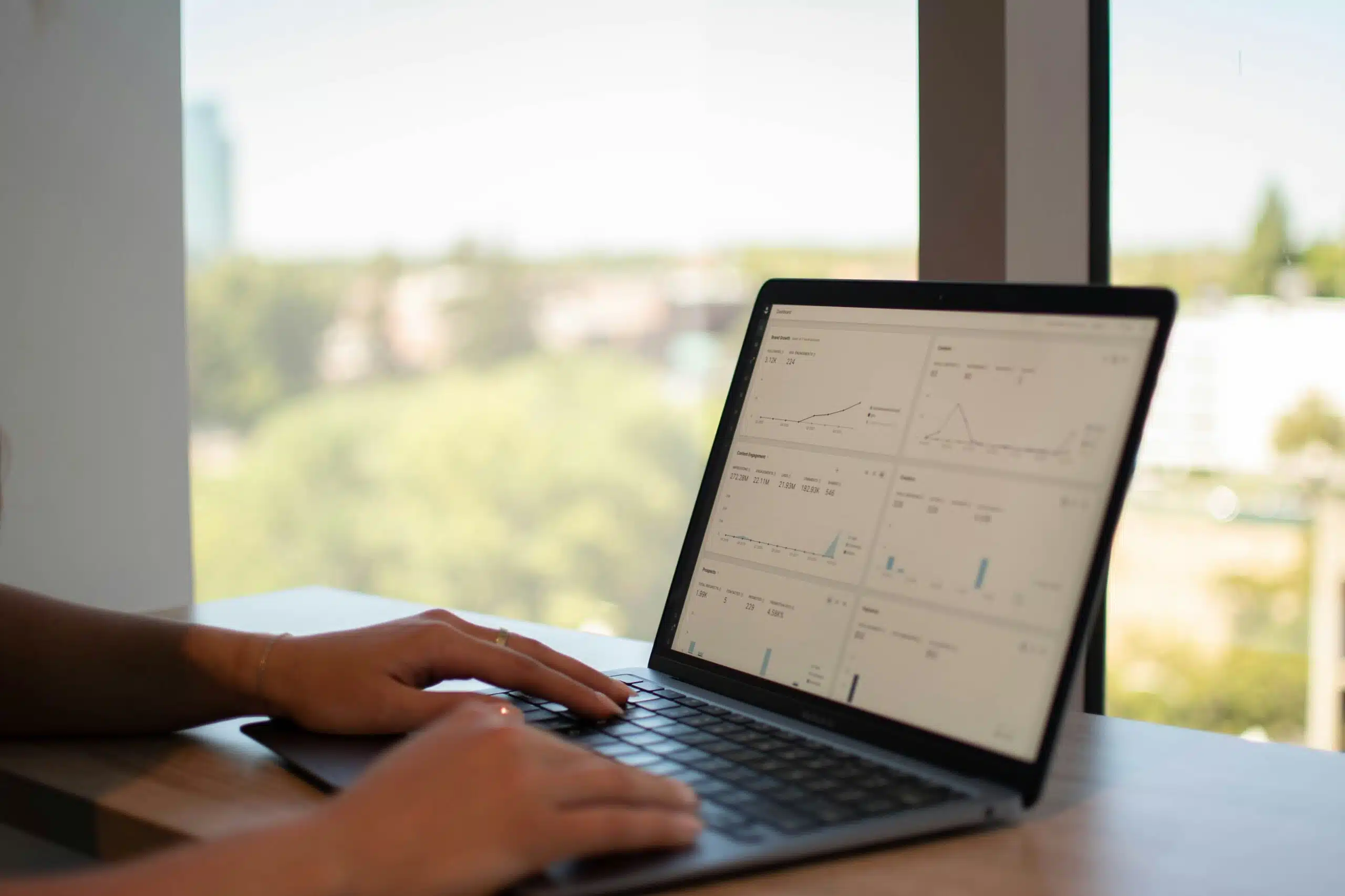 Person working on a marketing performance analysis on a laptop 