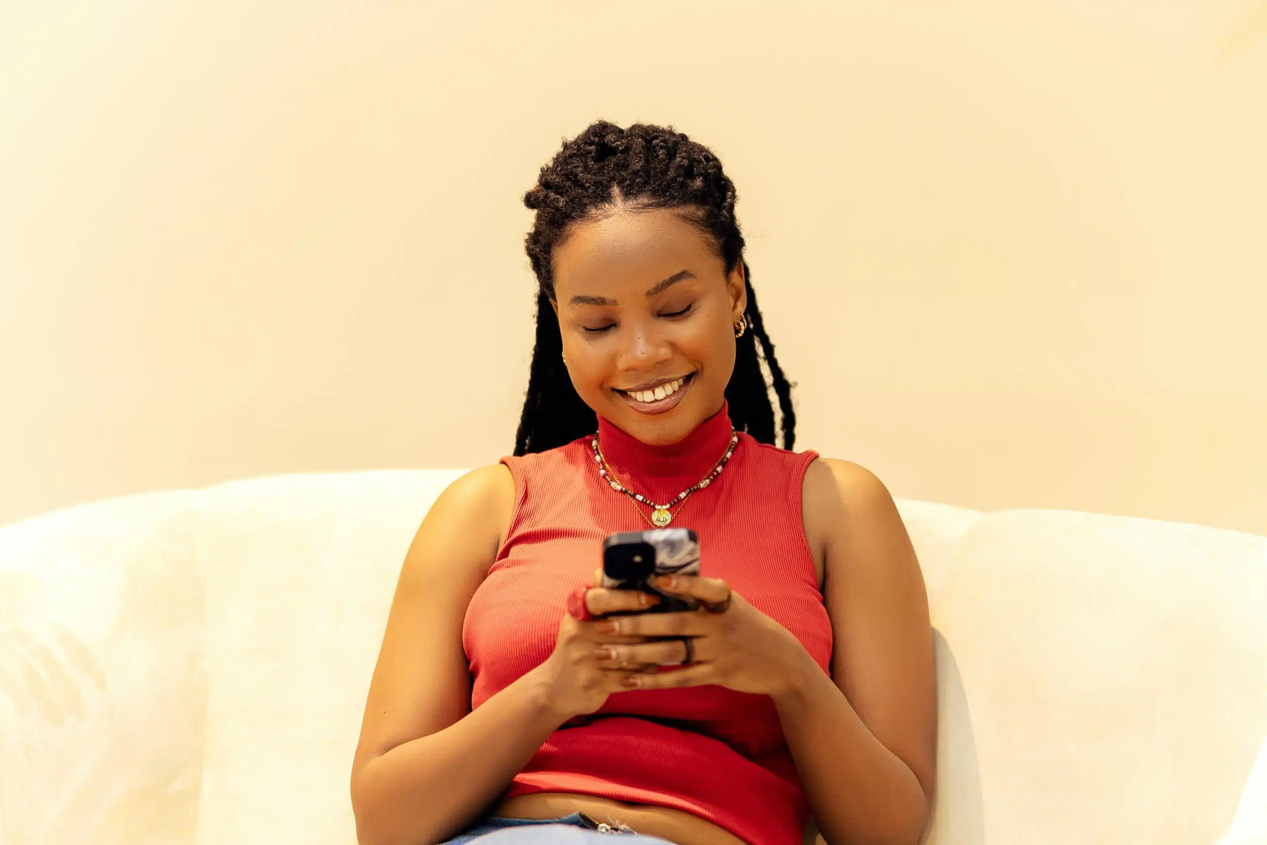 a person using her phone and smiling