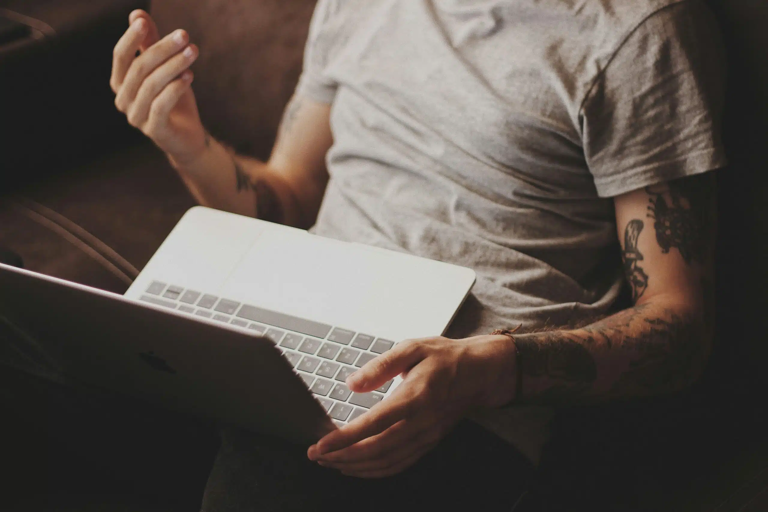  man holding laptop on his lap
