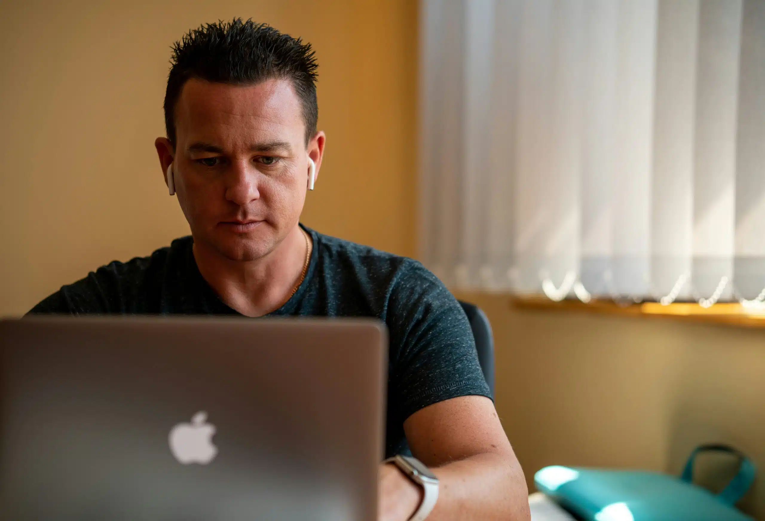a man working on a laptop remotely