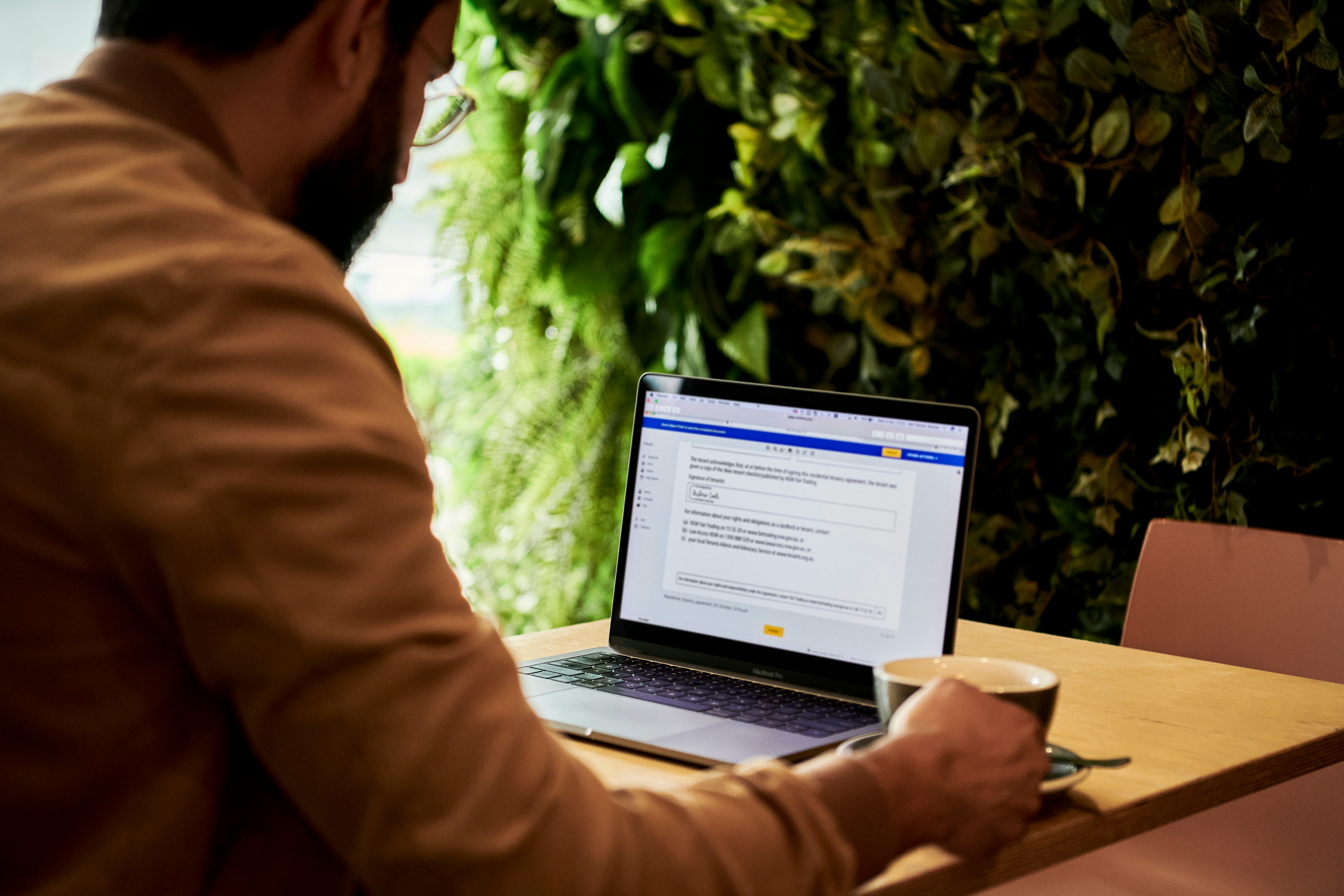 a man working at a cafe on his laptop