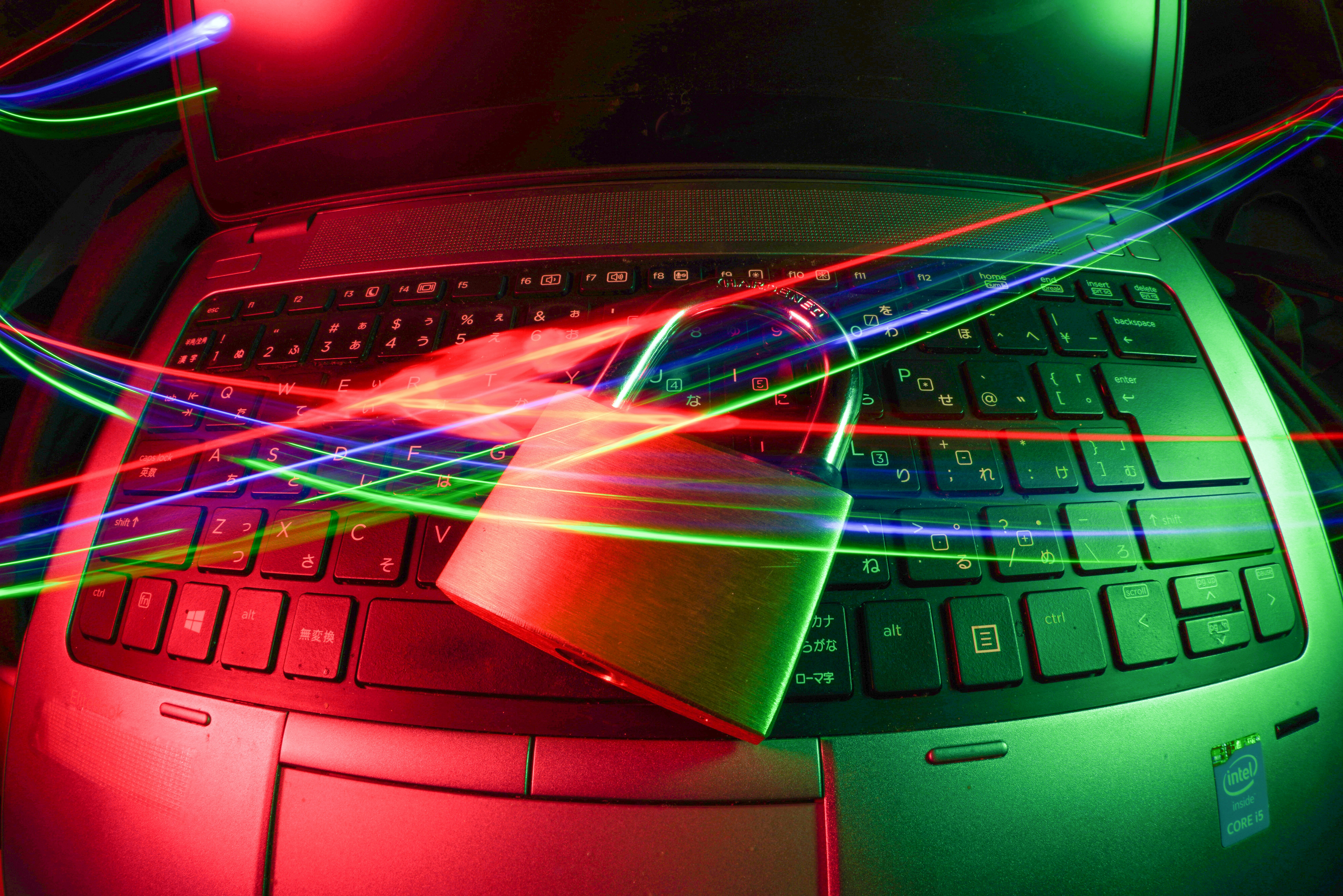 A padlock placed on a laptop keyboard surrounded by colorful light trails, symbolizing the enforcement of robust data encryption measures. - AI Marketing Tools A padlock placed on a laptop keyboard surrounded by colorful light trails, symbolizing the enforcement of robust data encryption measures.