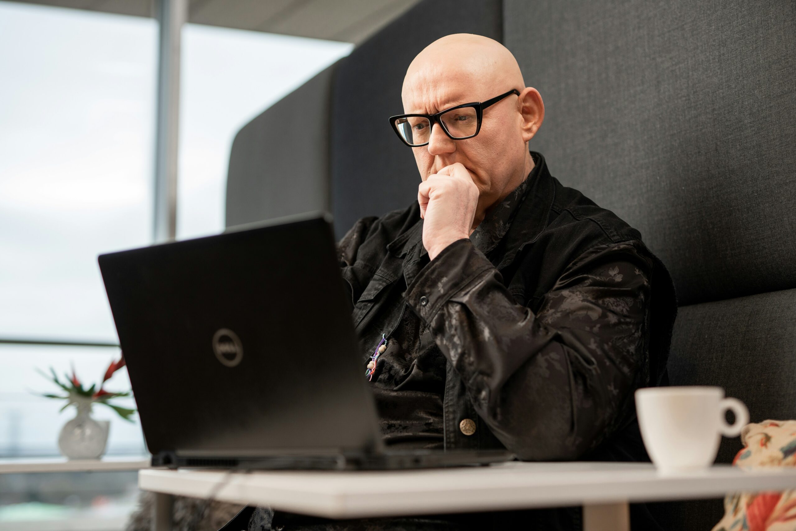 A person thoughtfully reviewing data on a laptop, emphasizing the importance of adopting clear data collection and purpose practices. - AI Marketing Tools A person thoughtfully reviewing data on a laptop, emphasizing the importance of adopting clear data collection and purpose practices.