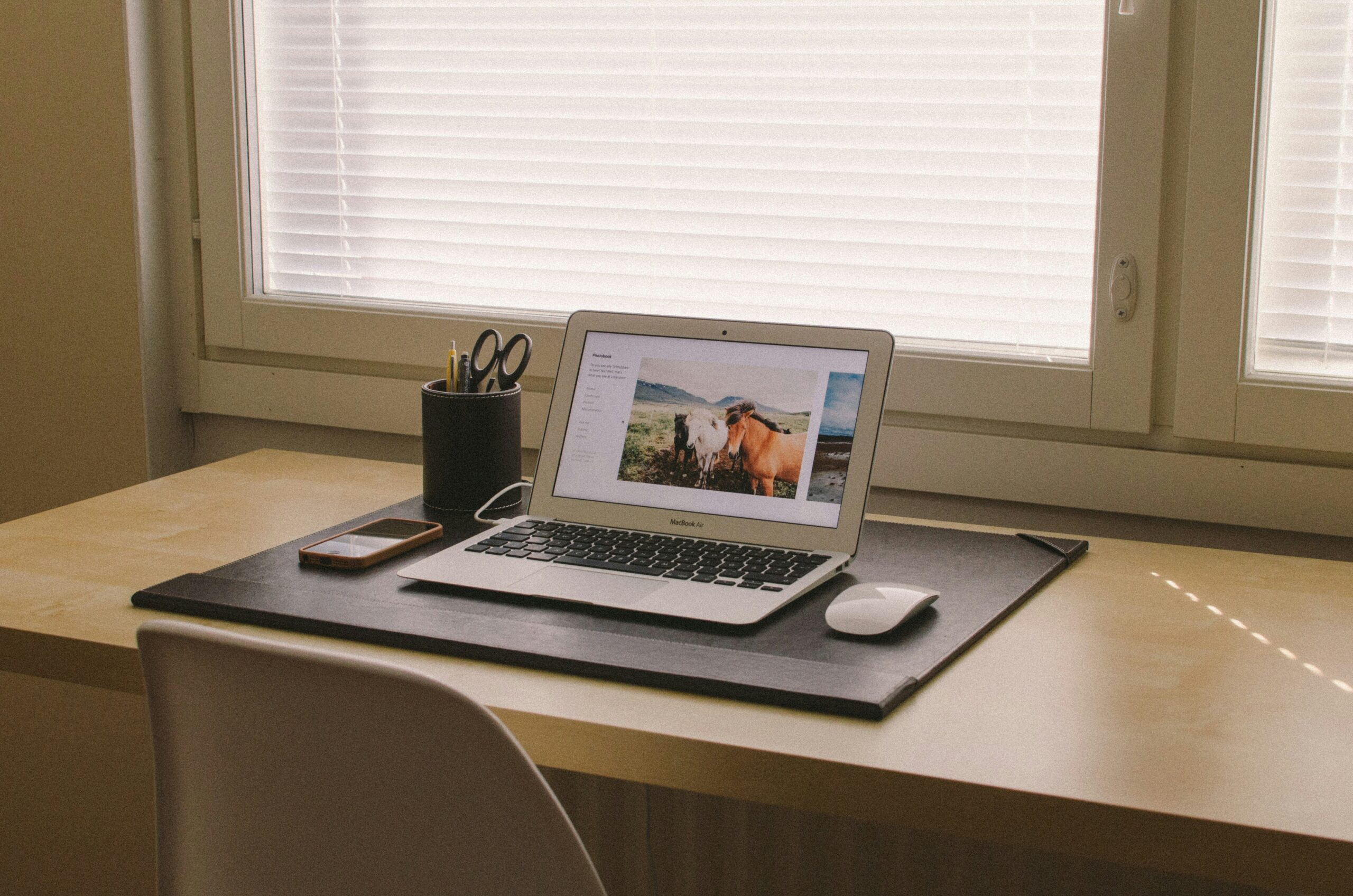 Minimal home workspace with laptop displaying digital content - AI Marketing Tools Minimal home workspace with laptop displaying digital content
