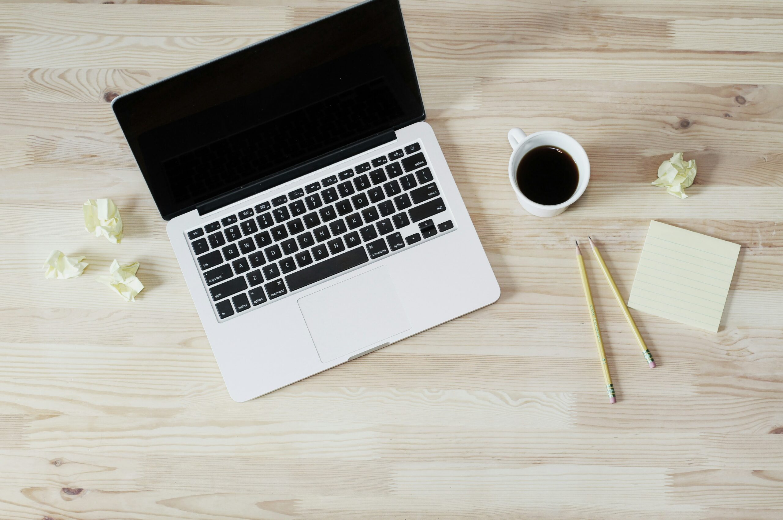 a laptop with a cup of coffee on a desk