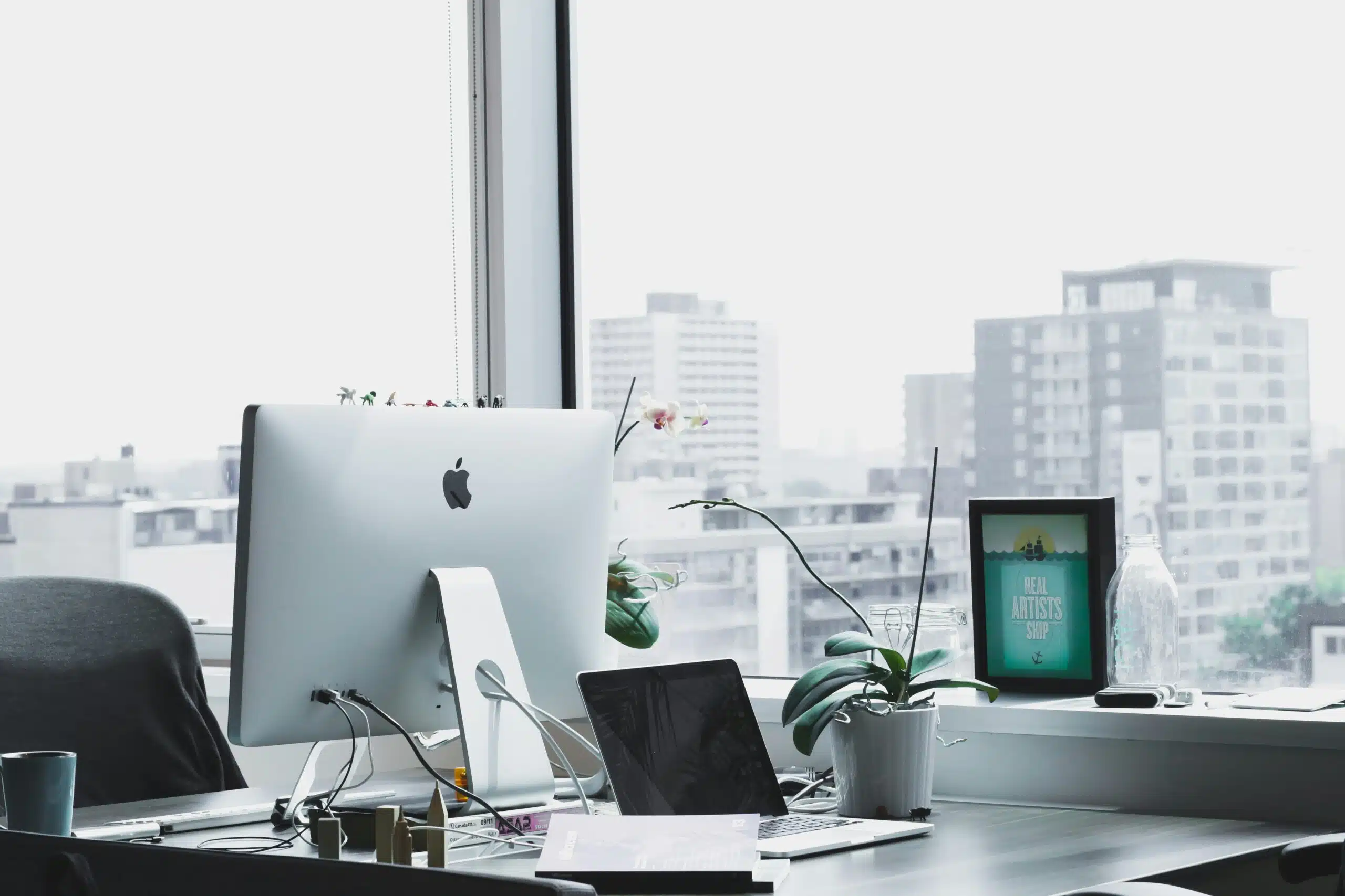 a well lit office space with view of city