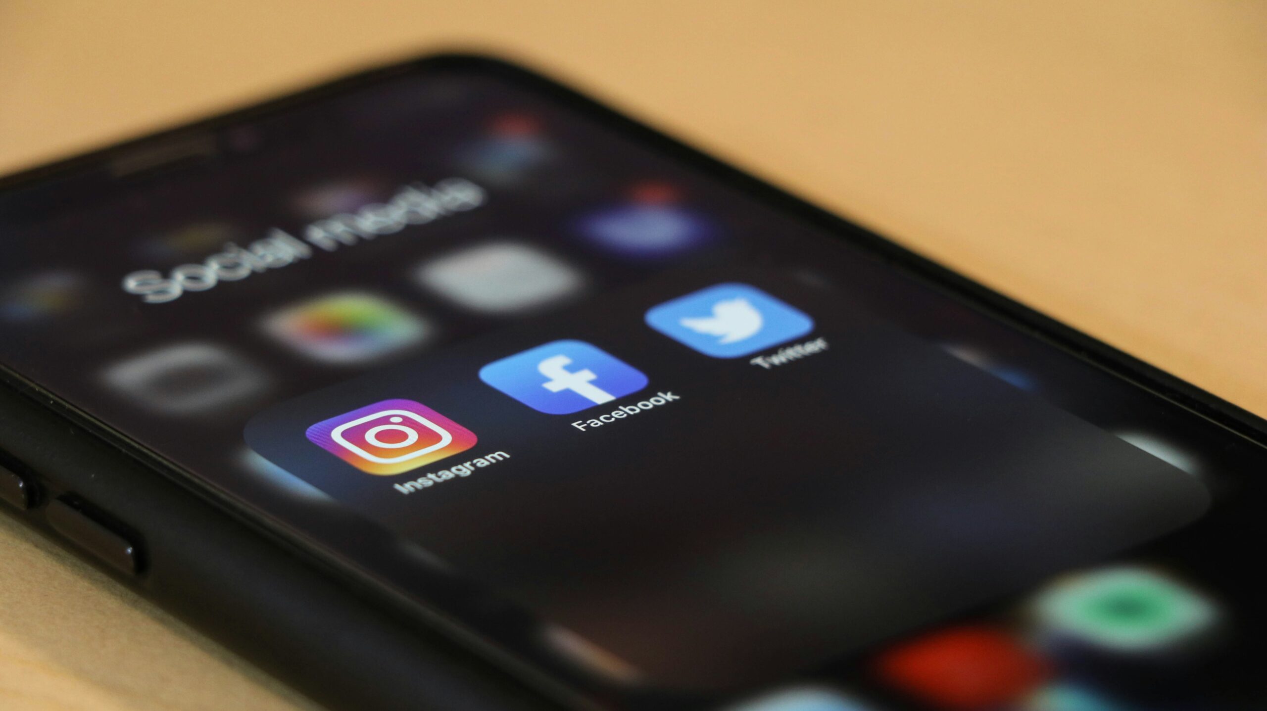 Smartphone screen displaying Instagram, Facebook, and Twitter apps under a social media folder. - AI Marketing Tools Smartphone screen displaying Instagram, Facebook, and Twitter apps under a social media folder.