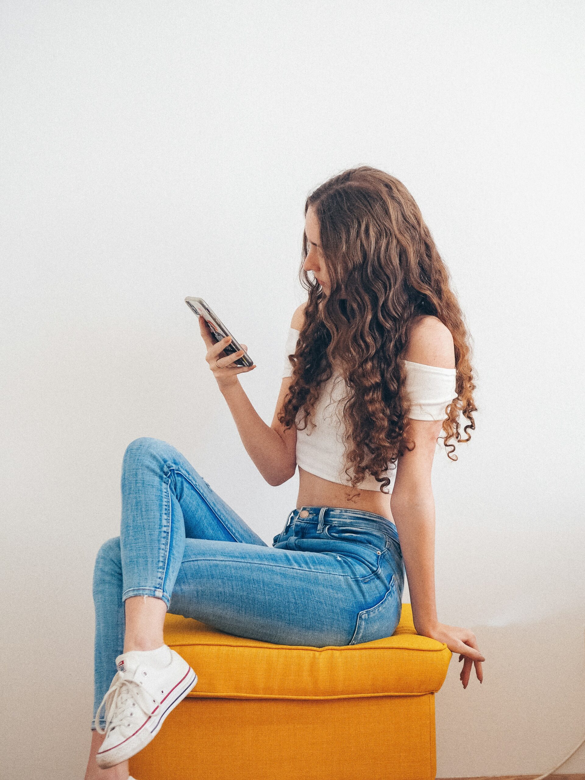 a woman using her phone - AI Marketing Tools a woman using her phone