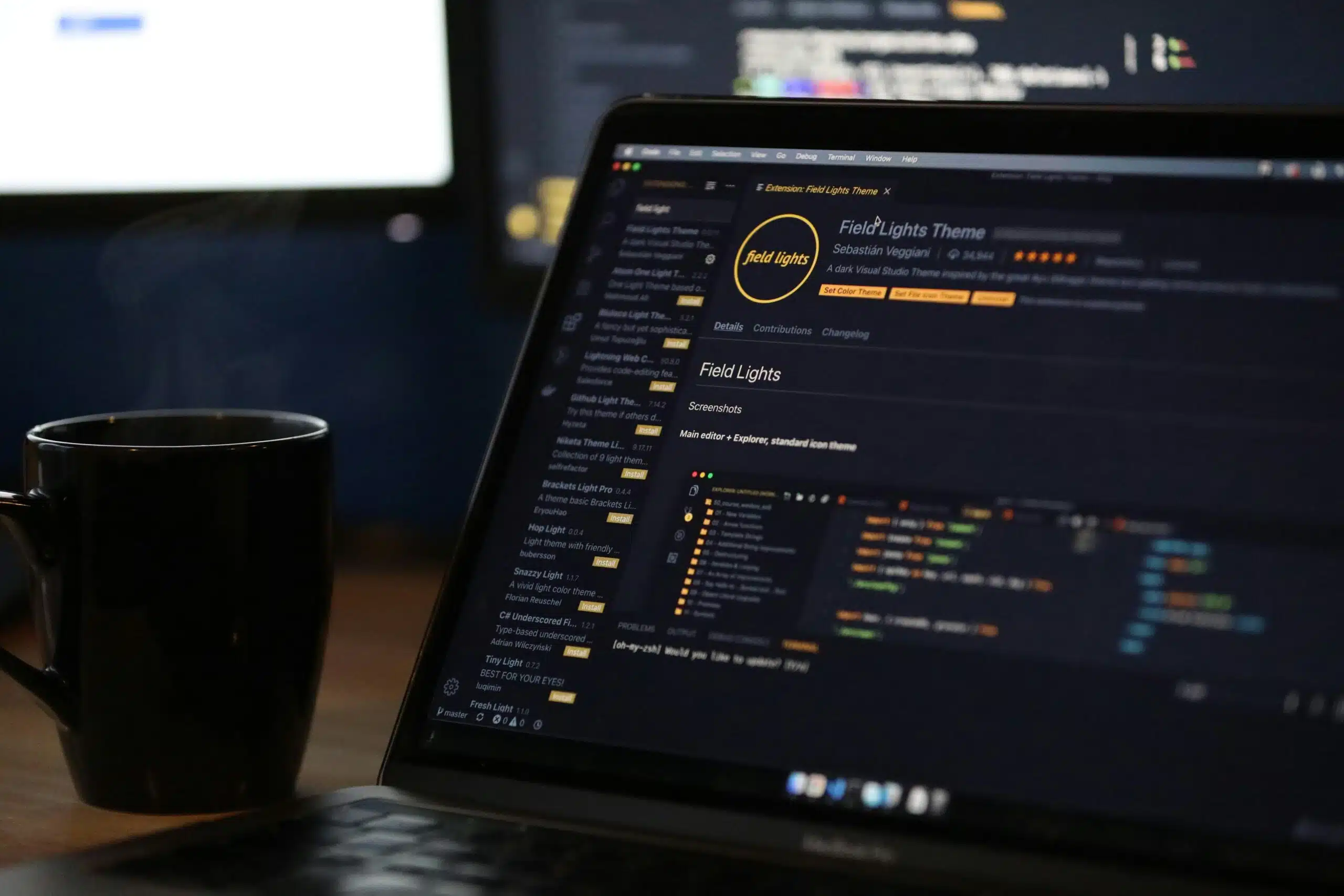 Dark-themed code editor open on a laptop beside a coffee mug, showing analytics plugin installation.