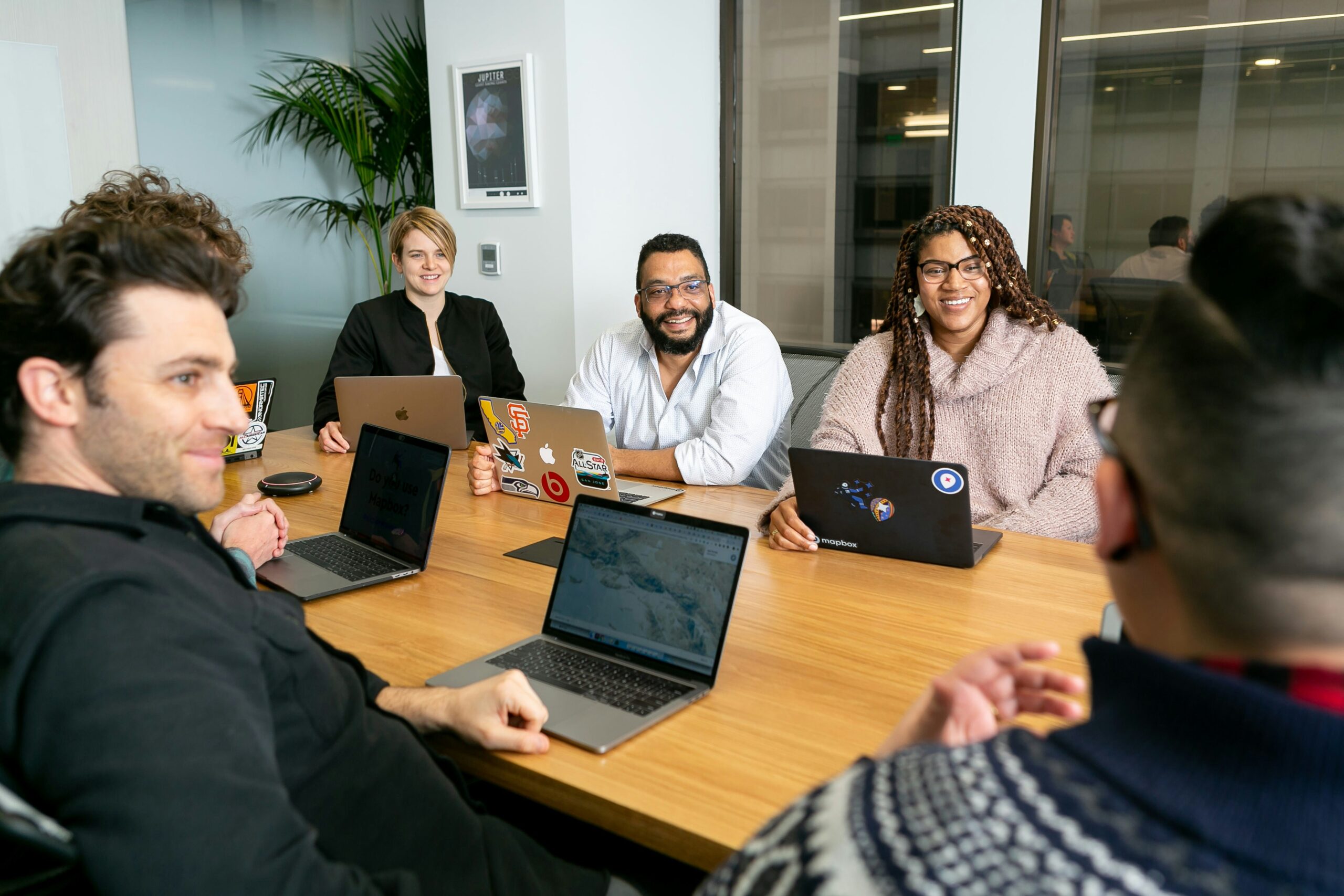 Team in a meeting room having a discussion - AI Marketing Tools Team in a meeting room having a discussion