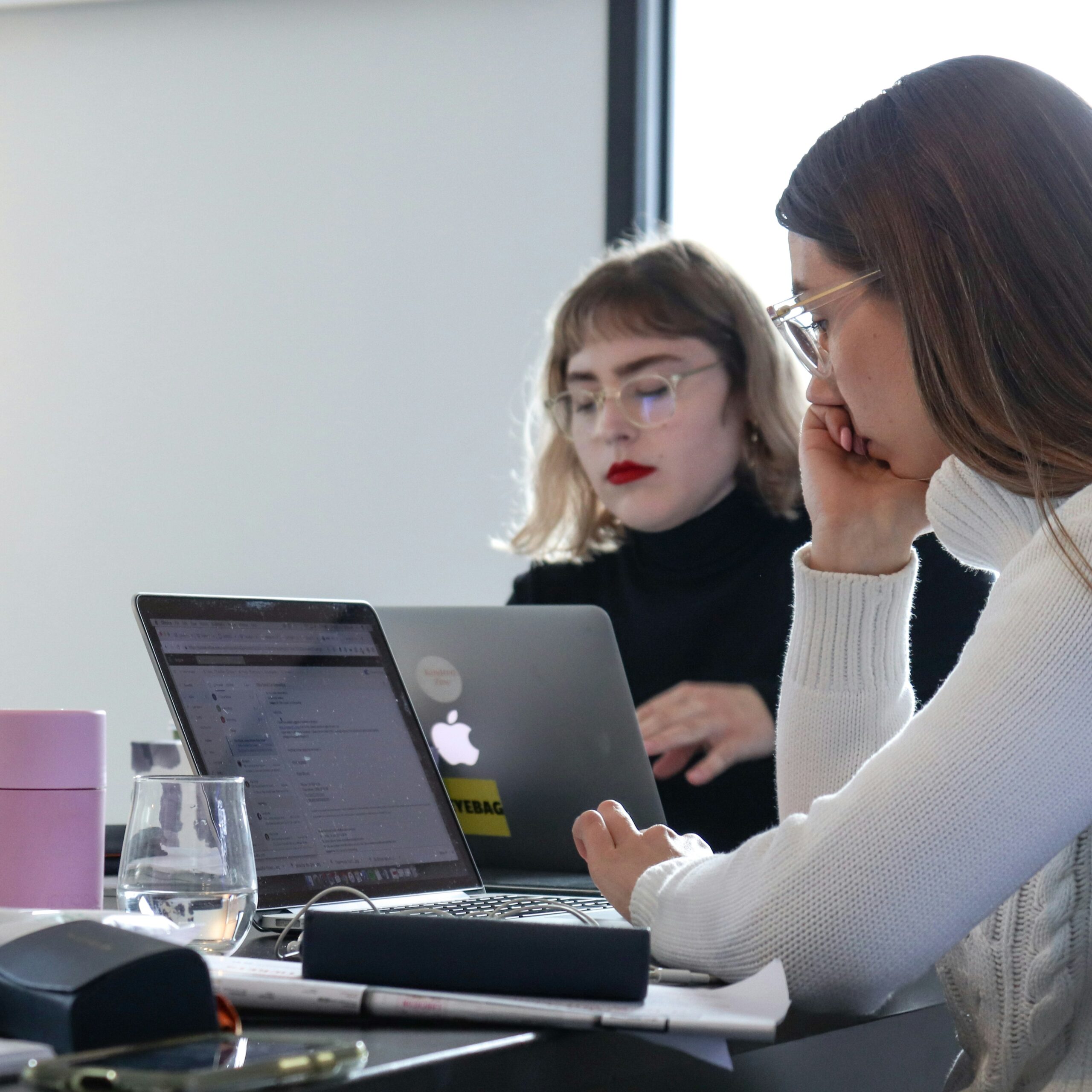 a marketing team working in a bright lit office - AI Marketing Tools a marketing team working in a bright lit office