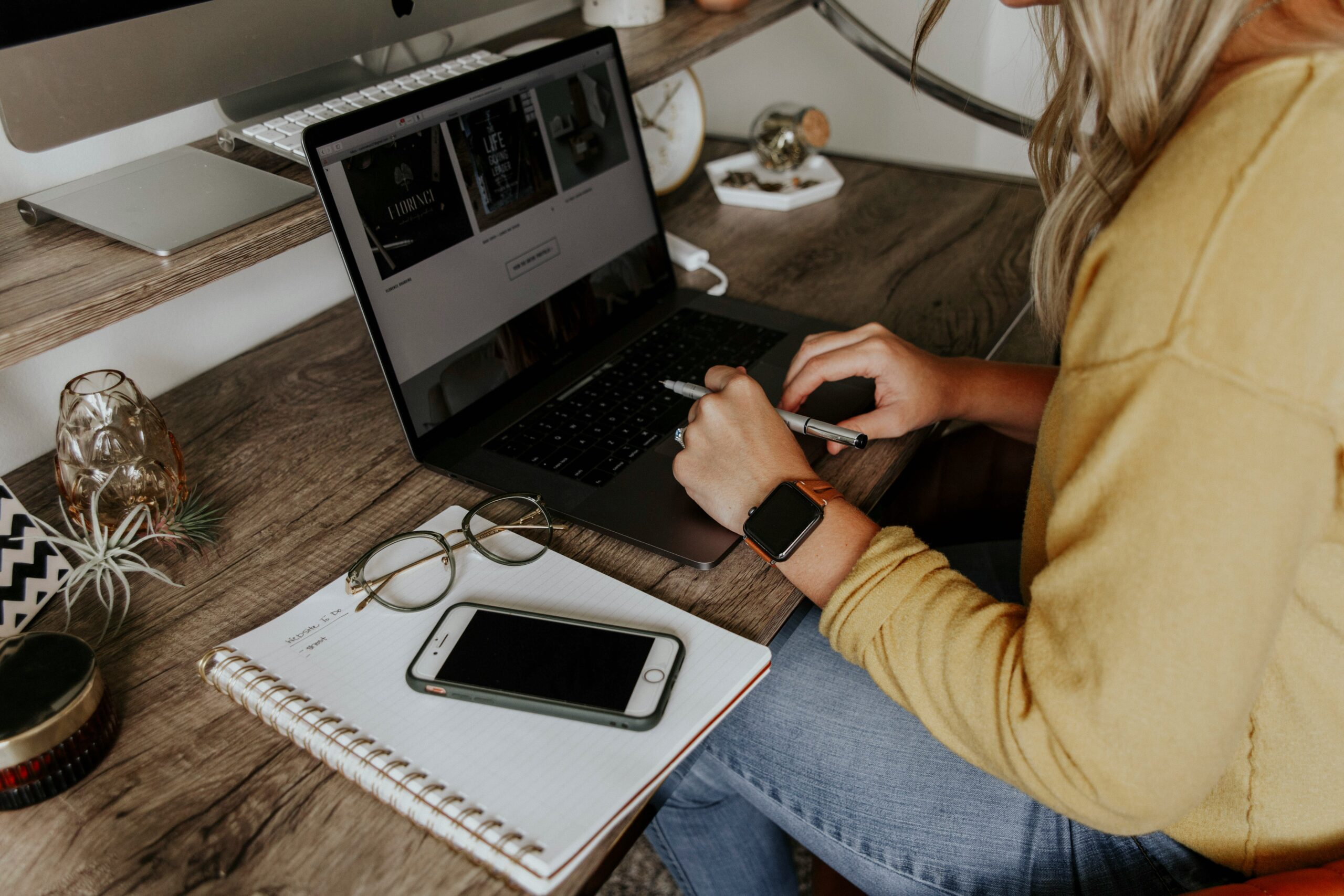 Woman reviewing an AI-driven advertising dashboard at her home workspace. - AI Marketing Tools Woman reviewing an AI-driven advertising dashboard at her home workspace.