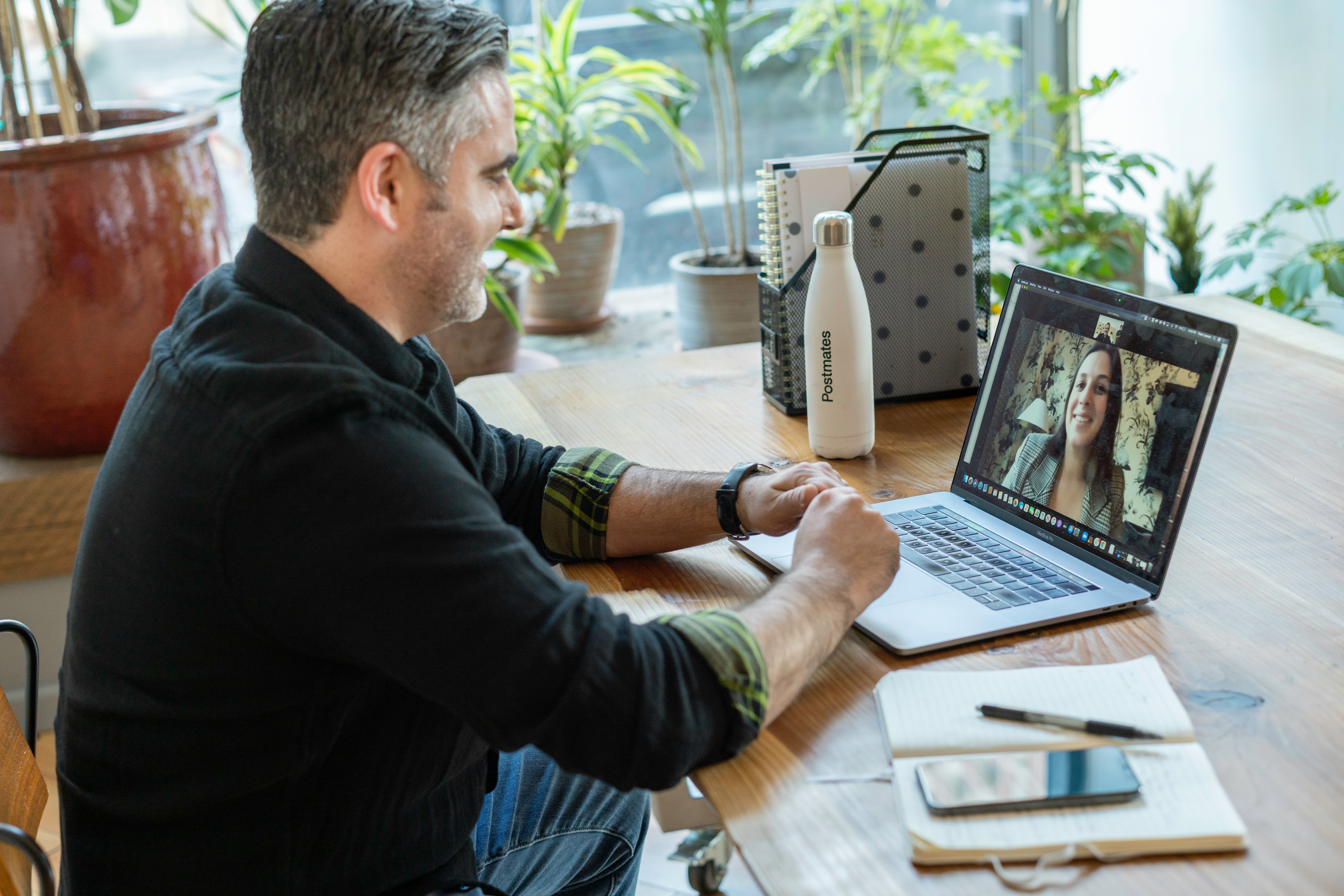 Man in a virtual meeting discussing digital advertising strategy on a laptop. - AI Marketing Tools Man in a virtual meeting discussing digital advertising strategy on a laptop.