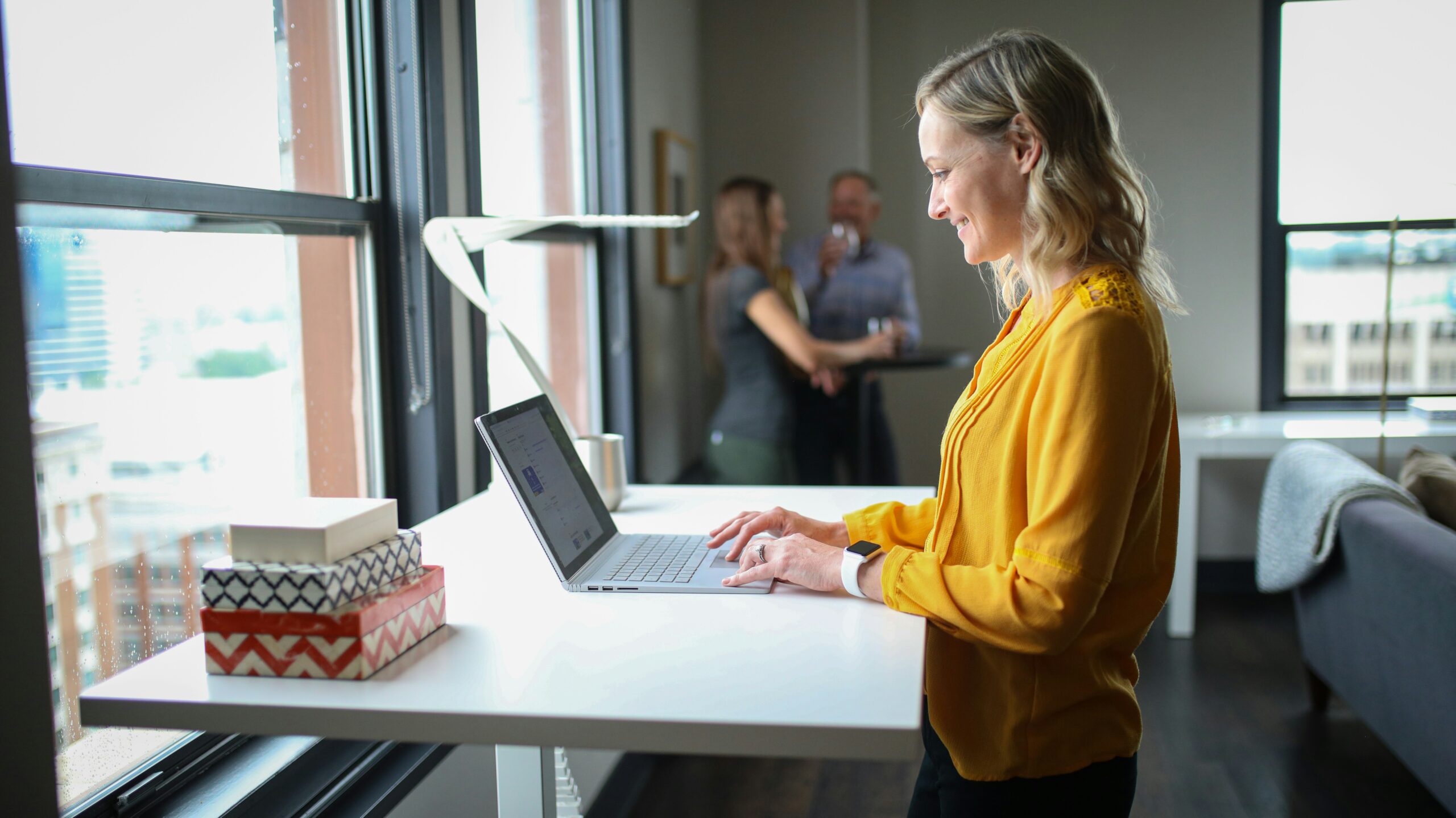 Marketer refining personalized content using AI analytics at a standing desk - AI Marketing Tools Marketer refining personalized content using AI analytics at a standing desk